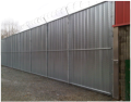 Chain link fencing with galvanized cladding for added security and privacy